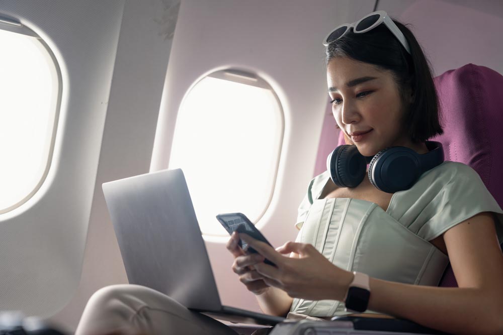 Student passenger of airplane read news from networks via smartphone and wifi on board. tourism traveler concept